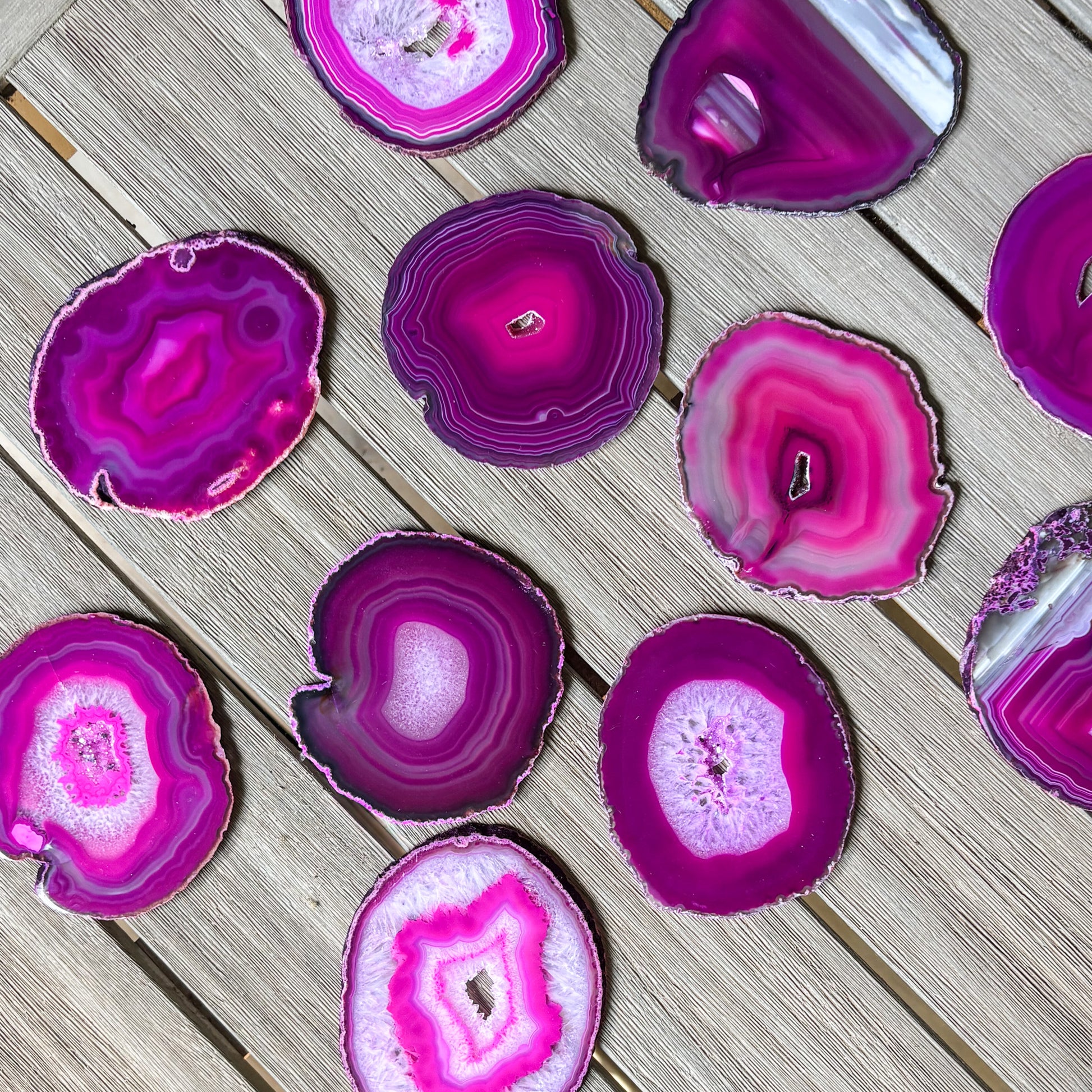 Luxury fuchsia agate coaster set with organic crystal formations and polished finish for coffee tables and bars.