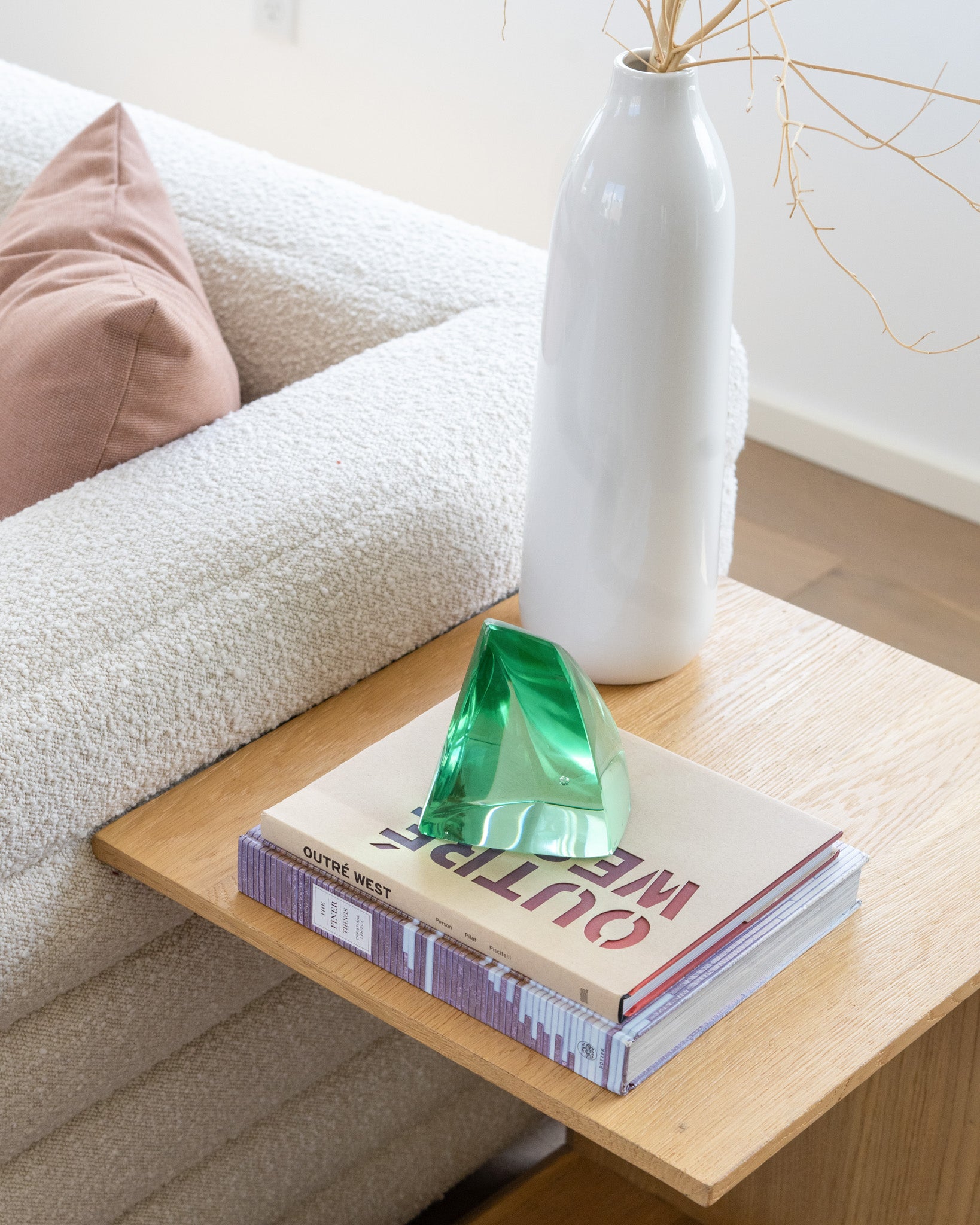 Sculptural green glass decor on a wooden living room table