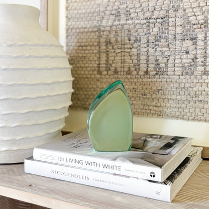 Minimalist green glass sculpture with clean abstract lines