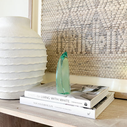 Contemporary green glass sculpture on coffee table with natural light