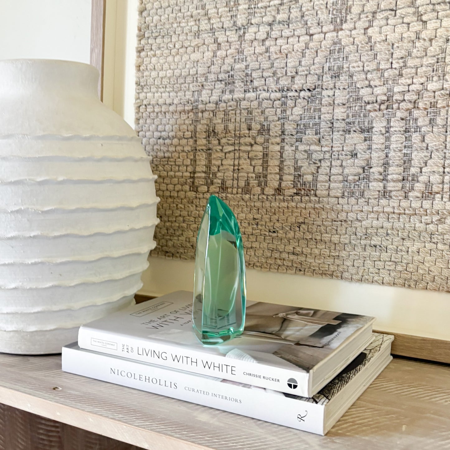 Green hand-blown glass sculpture with modern abstract curved form