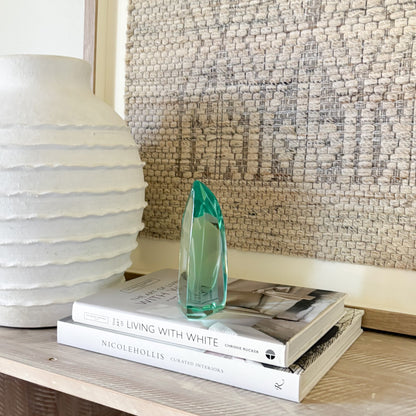 Green hand-blown glass sculpture with modern abstract curved form