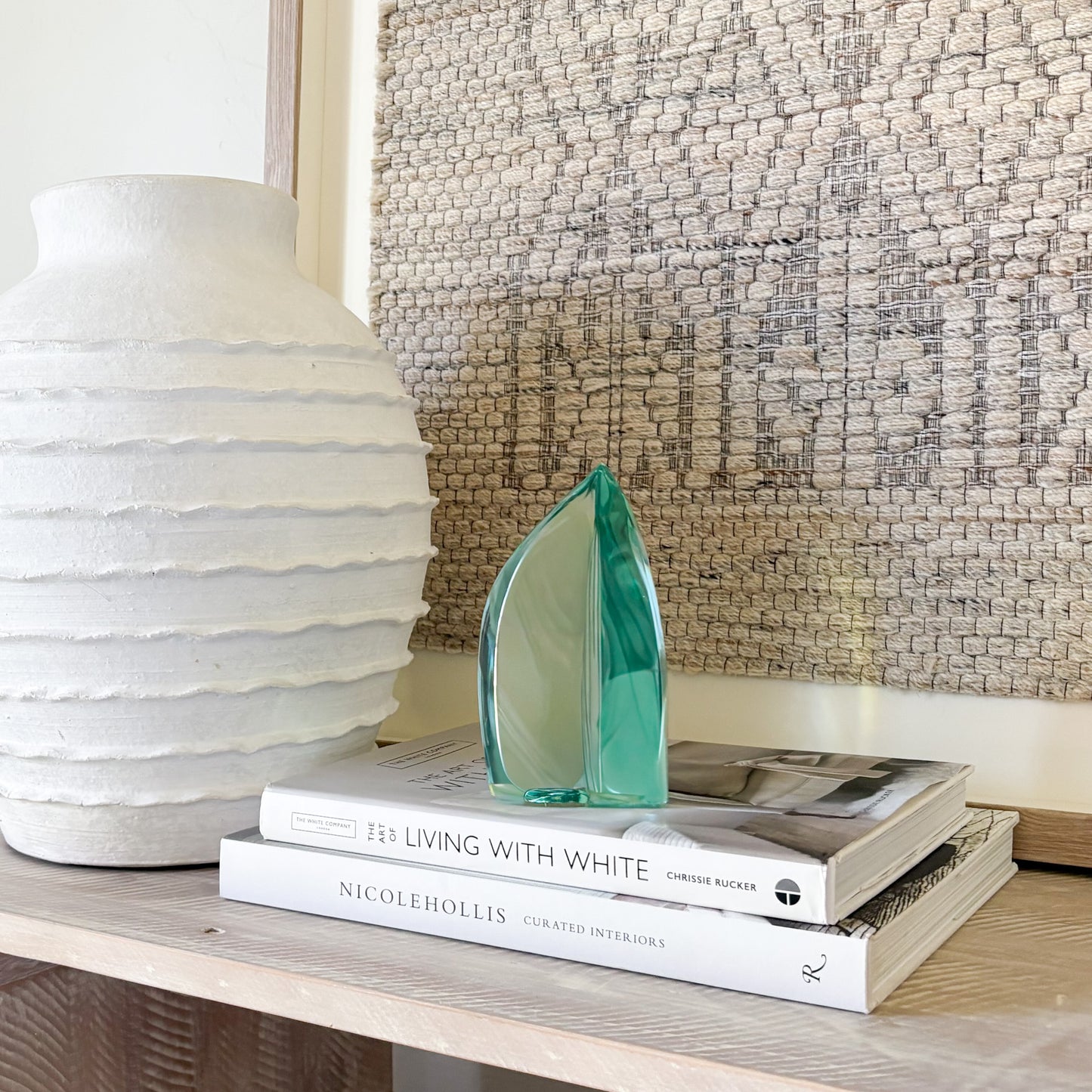 Green glass sculpture shown with book for size reference