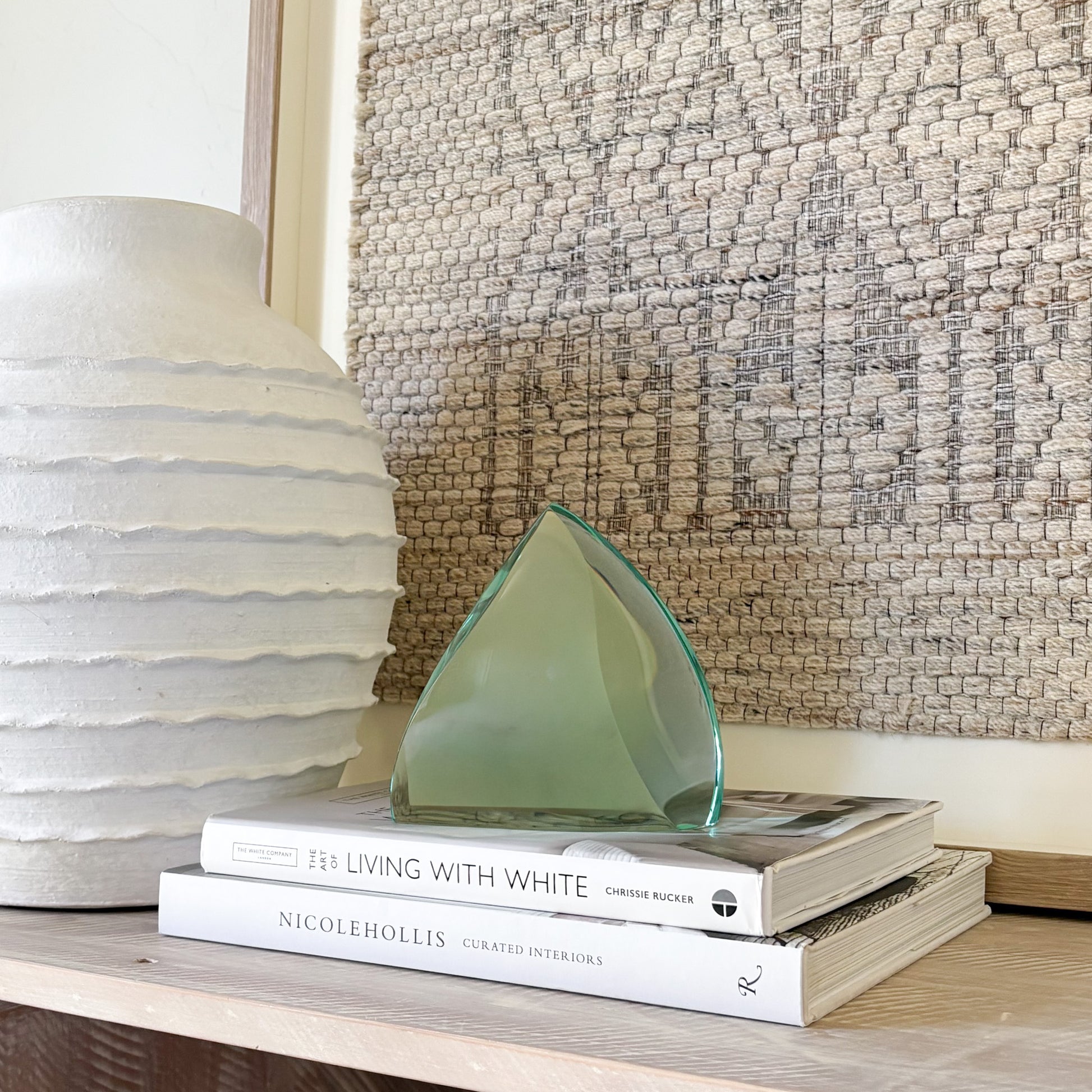 Handcrafted green glass art sculpture with smooth curved silhouette