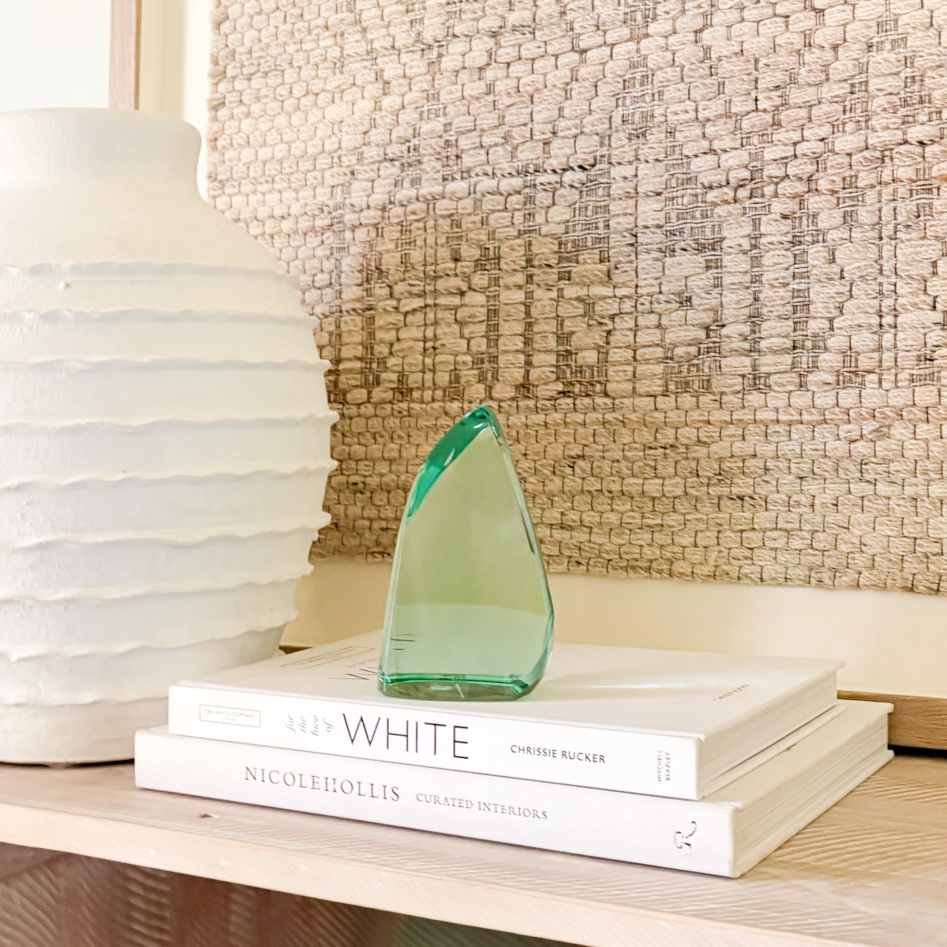 Abstract green glass sculpture on a shelf