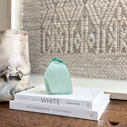 Contemporary green glass sculpture on coffee table with natural light