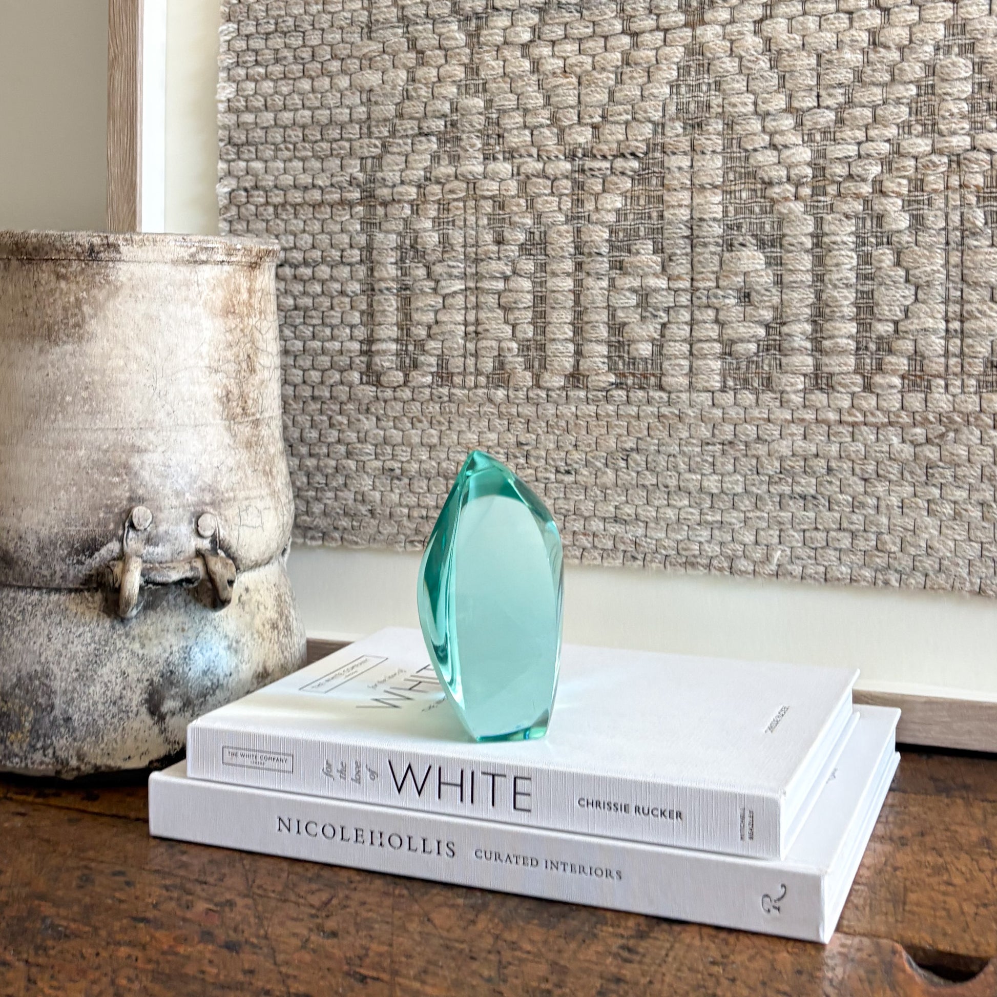 Handcrafted green glass art sculpture with smooth curved silhouette