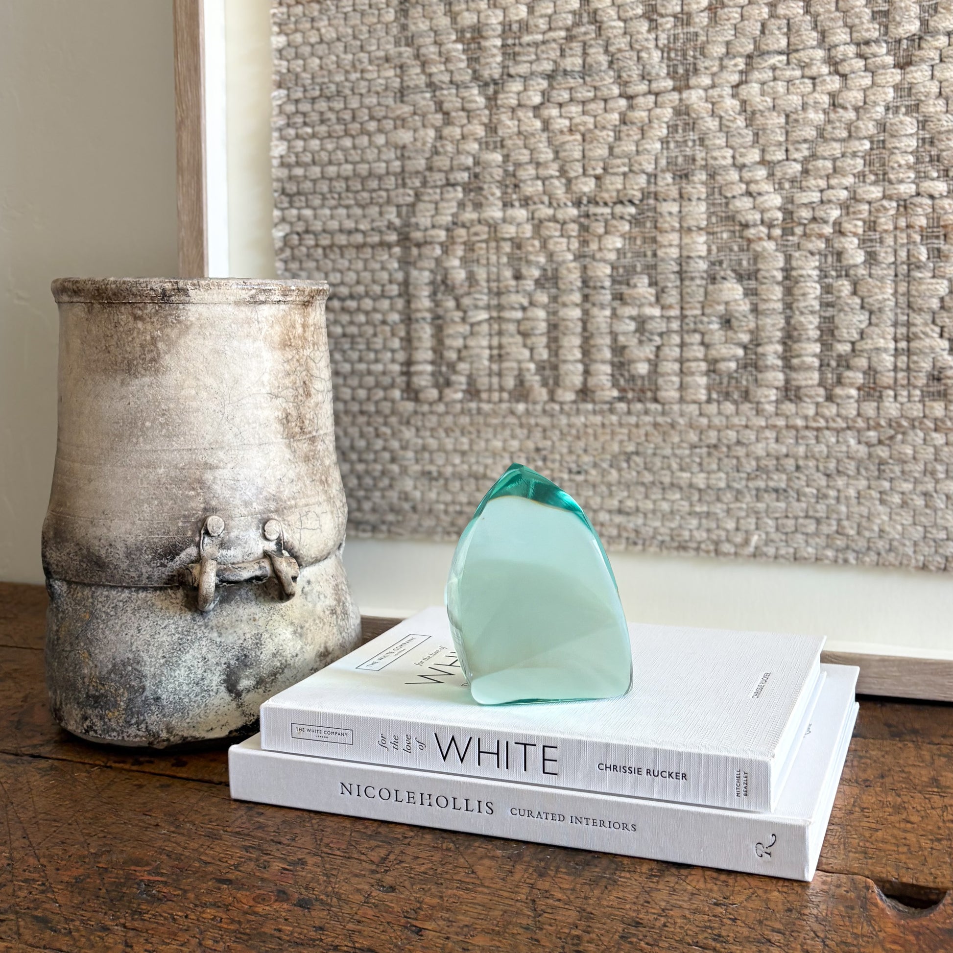 Green glass sculpture top view showing flowing abstract shape