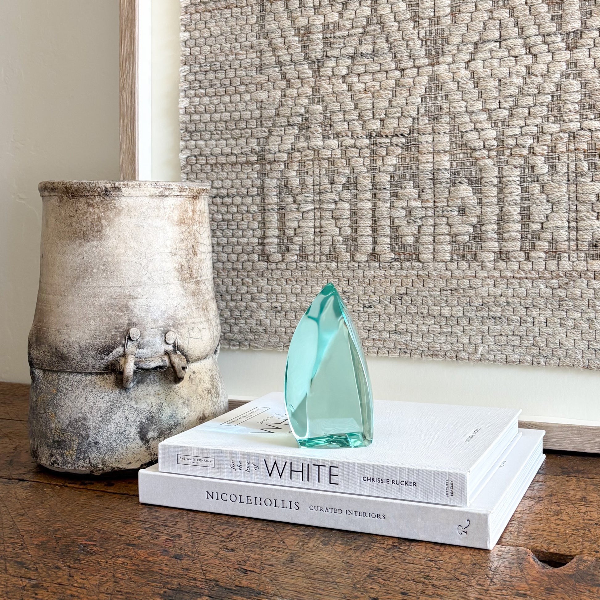 Handcrafted green glass art sculpture with smooth curved silhouette