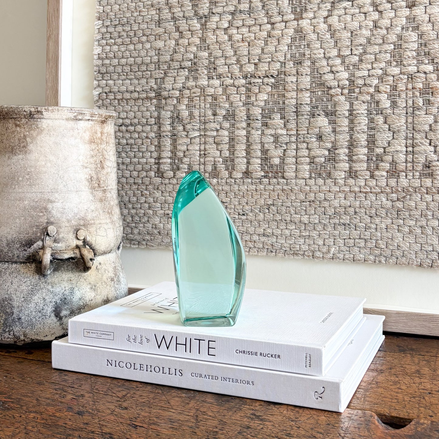 Handcrafted green glass art sculpture with smooth curved silhouette