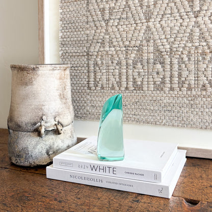 Contemporary green glass sculpture on coffee table with natural light