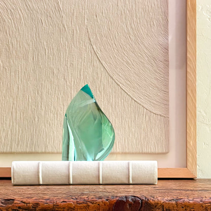 Artisan green glass sculpture with translucent finish and abstract form