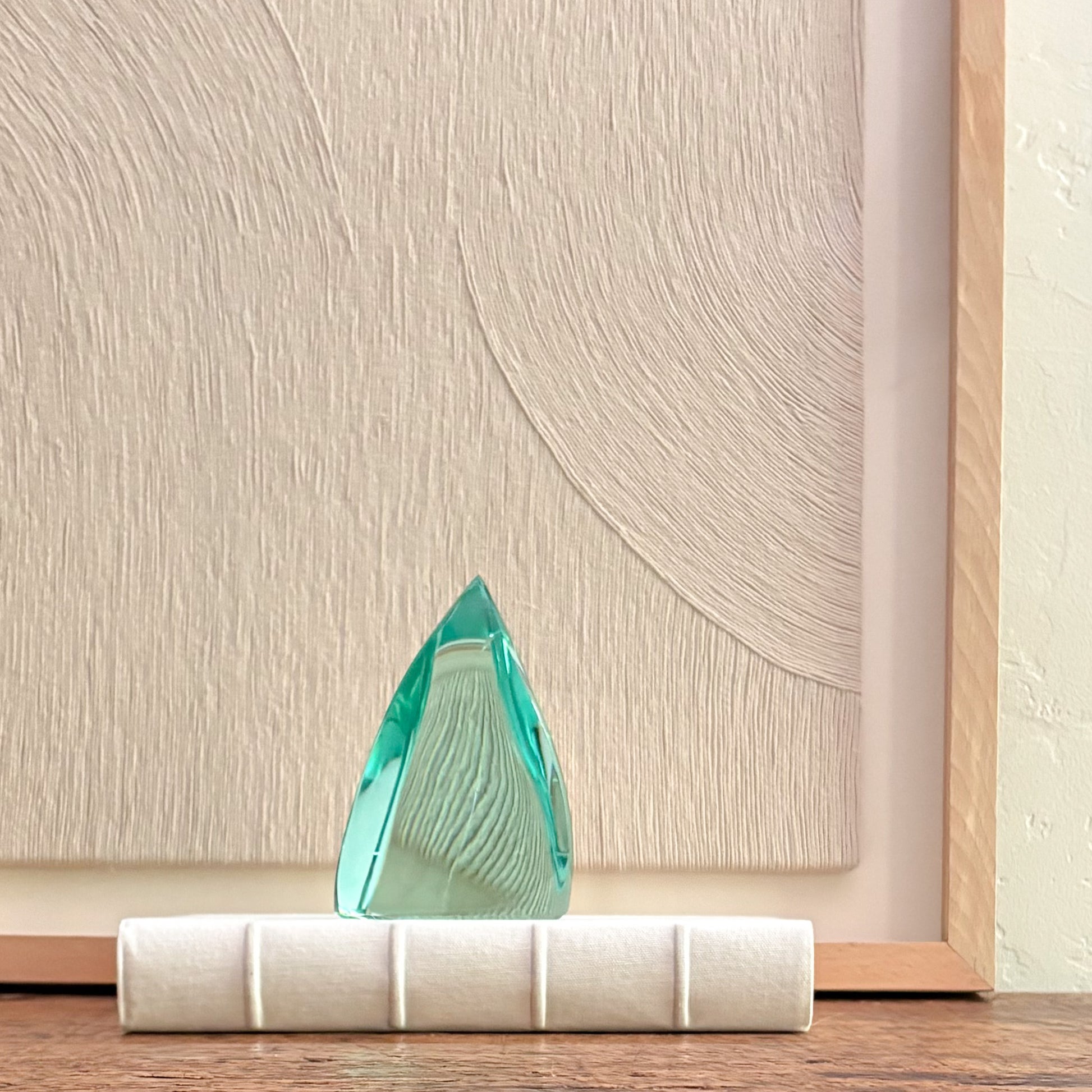 Decorative green glass sculpture with angular crystal shape for minimalist interior