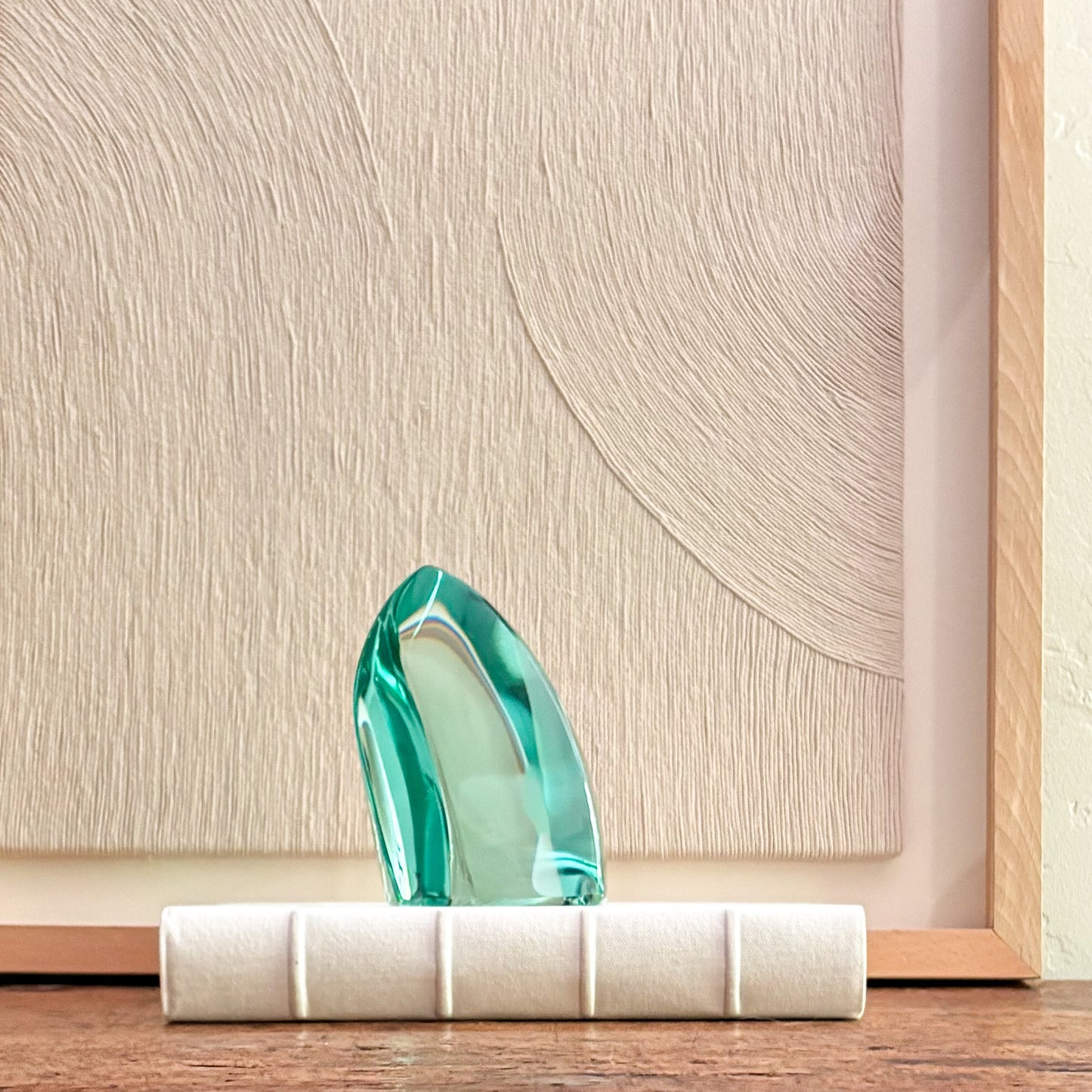 Contemporary green glass art sculpture with polished edges and translucent finish