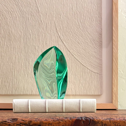 Artisan green glass sculpture with translucent finish and abstract form
