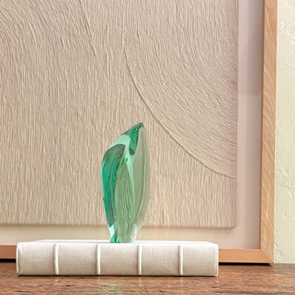 Abstract green glass sculpture with glossy finish
