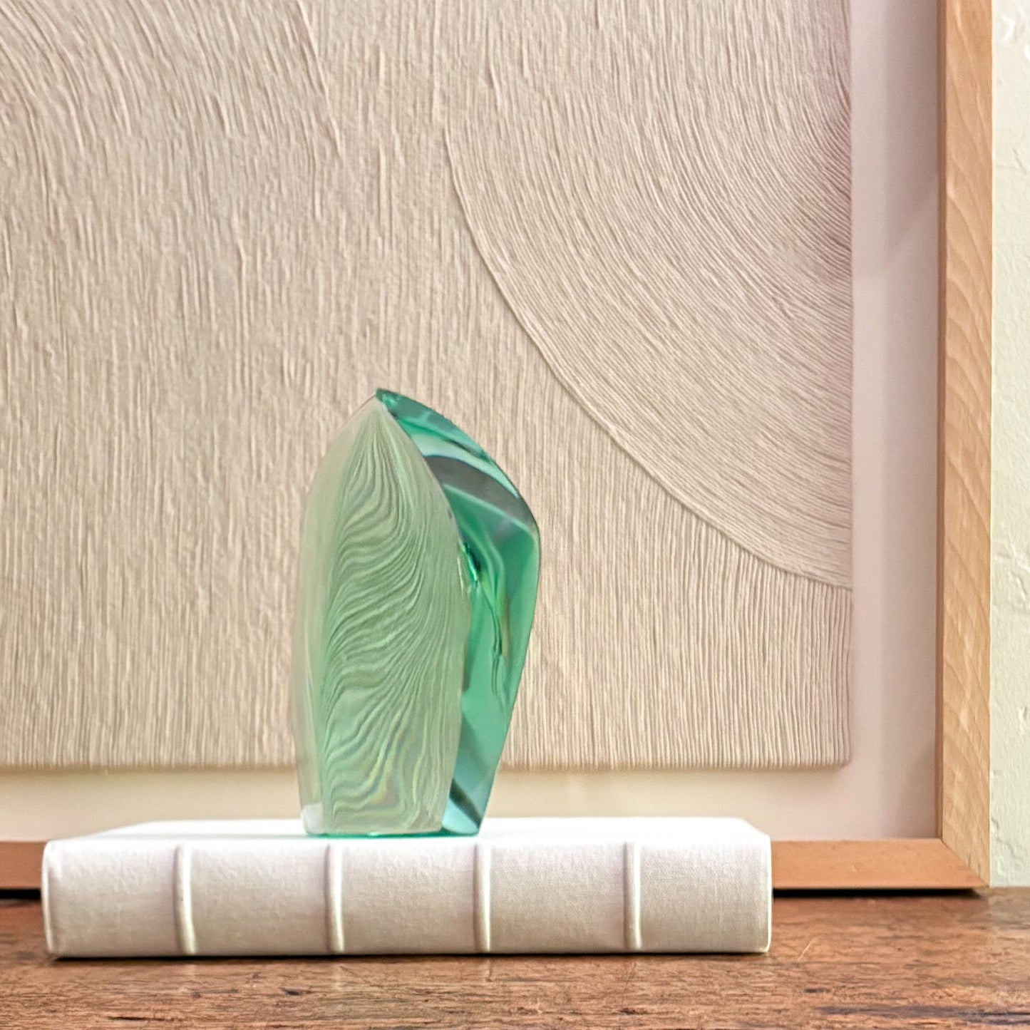 Contemporary green glass art sculpture with polished edges and translucent finish