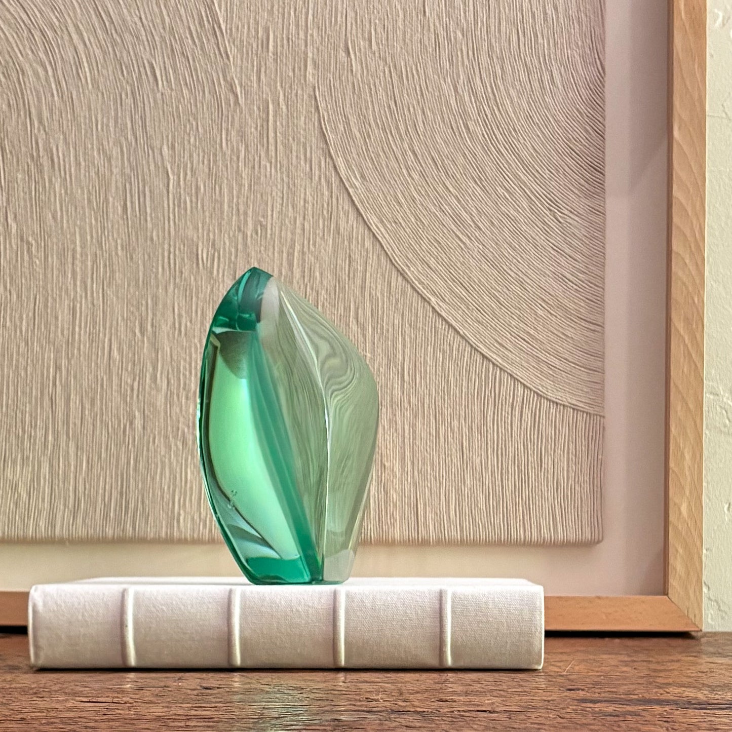 Decorative green glass sculpture with angular crystal shape for minimalist interior