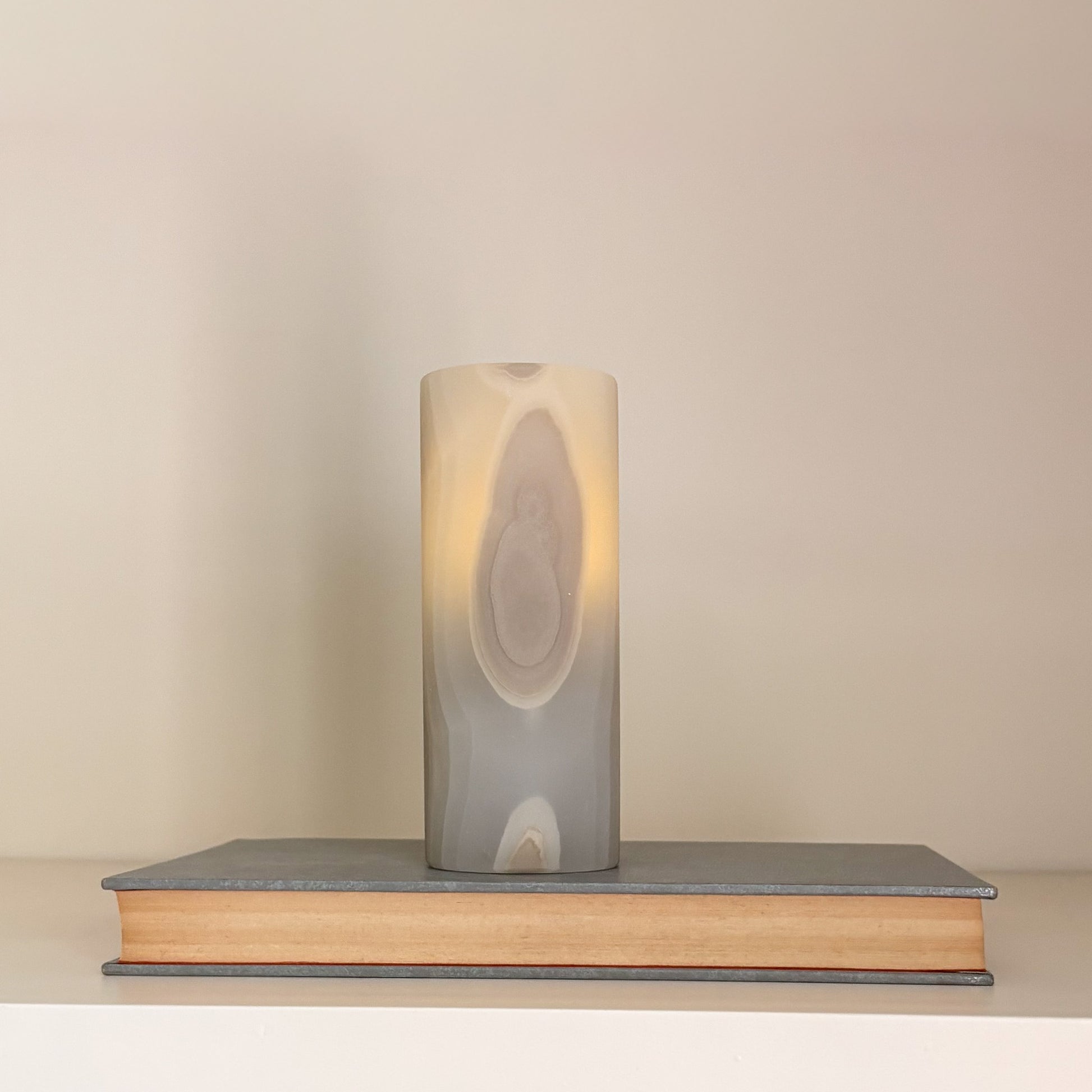 High-end artisanal candle holders in polished grey aragonite crystal