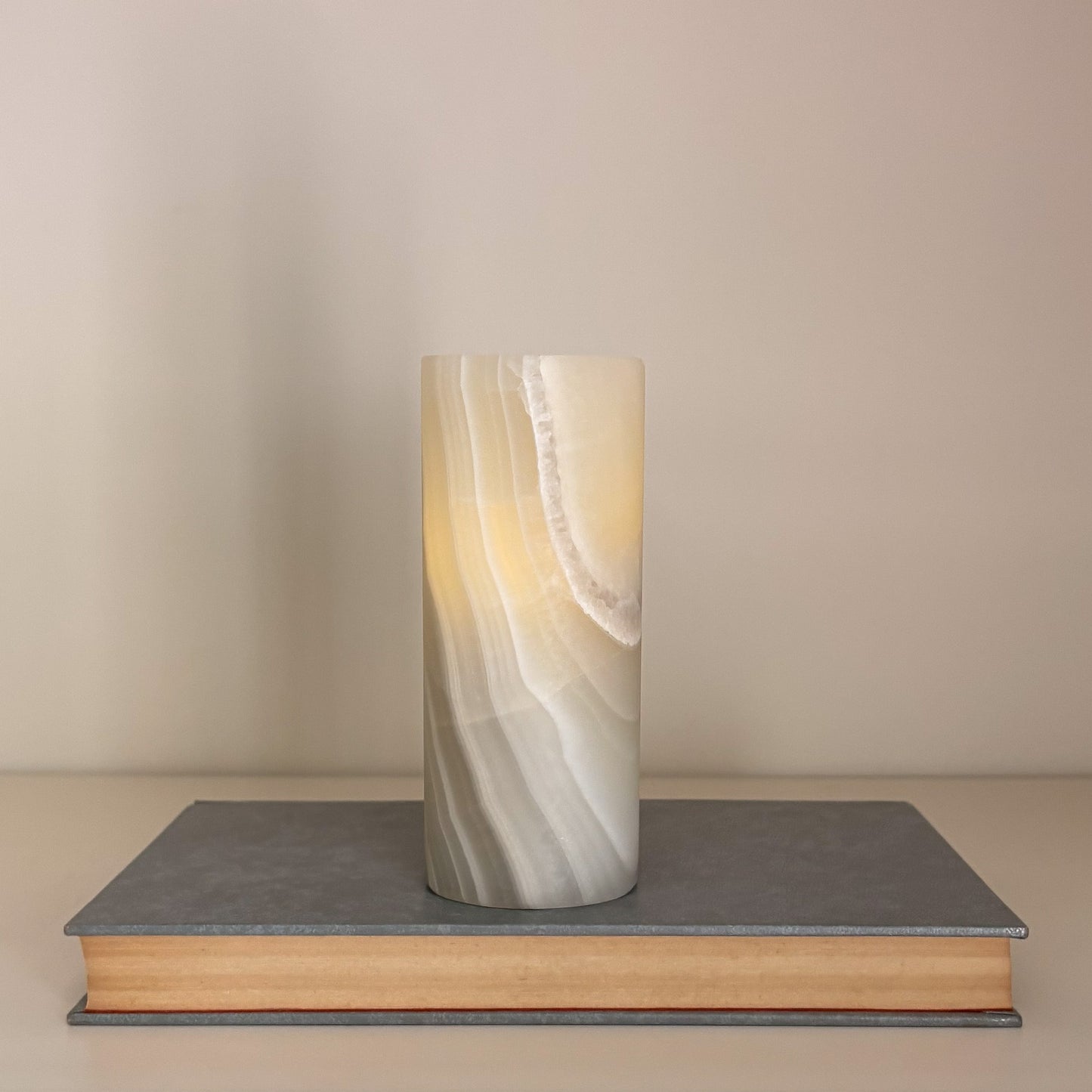 Neutral-toned stone candle holders styled in sophisticated minimalist interior
