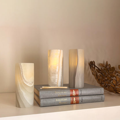 Minimalist artisanal candle holders carved from natural grey aragonite stone