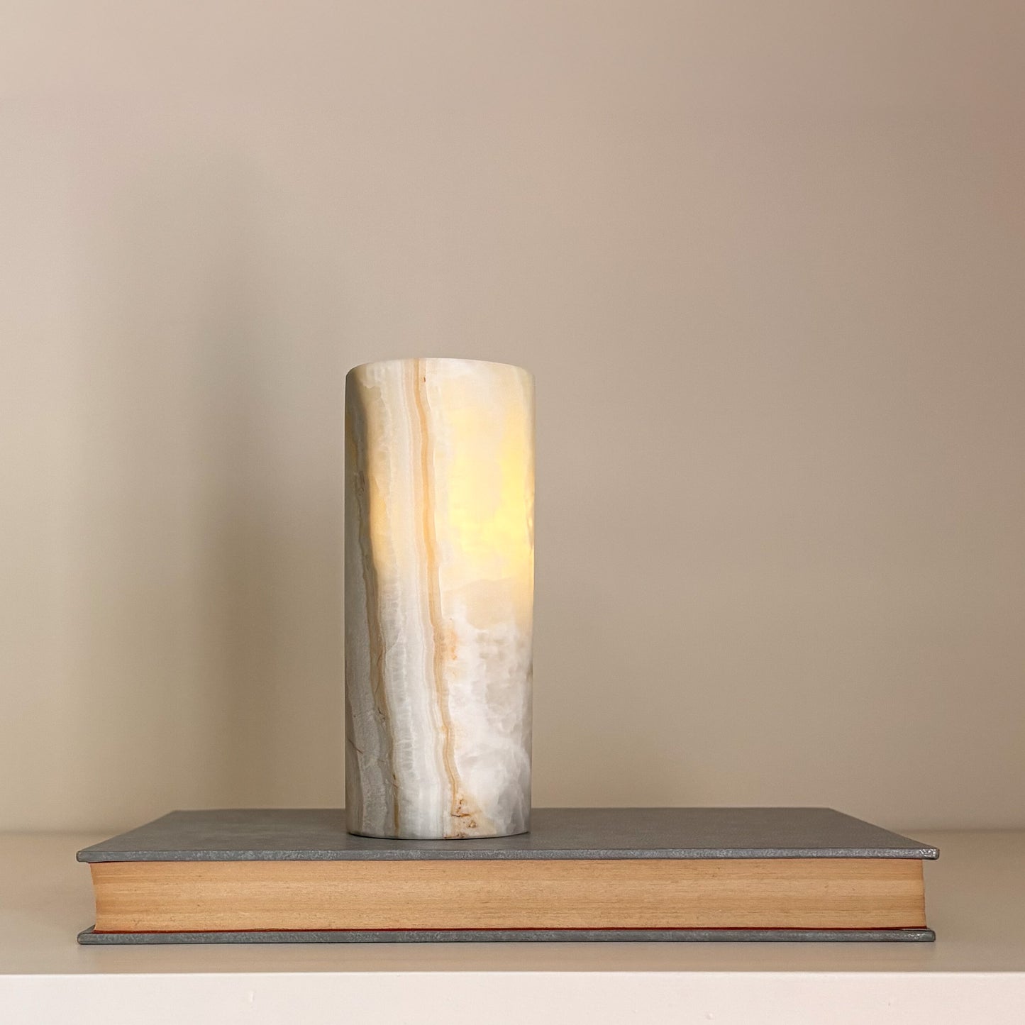 Natural stone tealight holders with translucent aragonite veining and soft candlelight