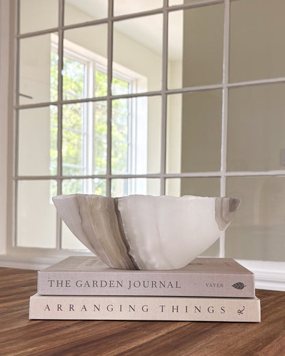 Grey onyx stone bowl with layered natural veining