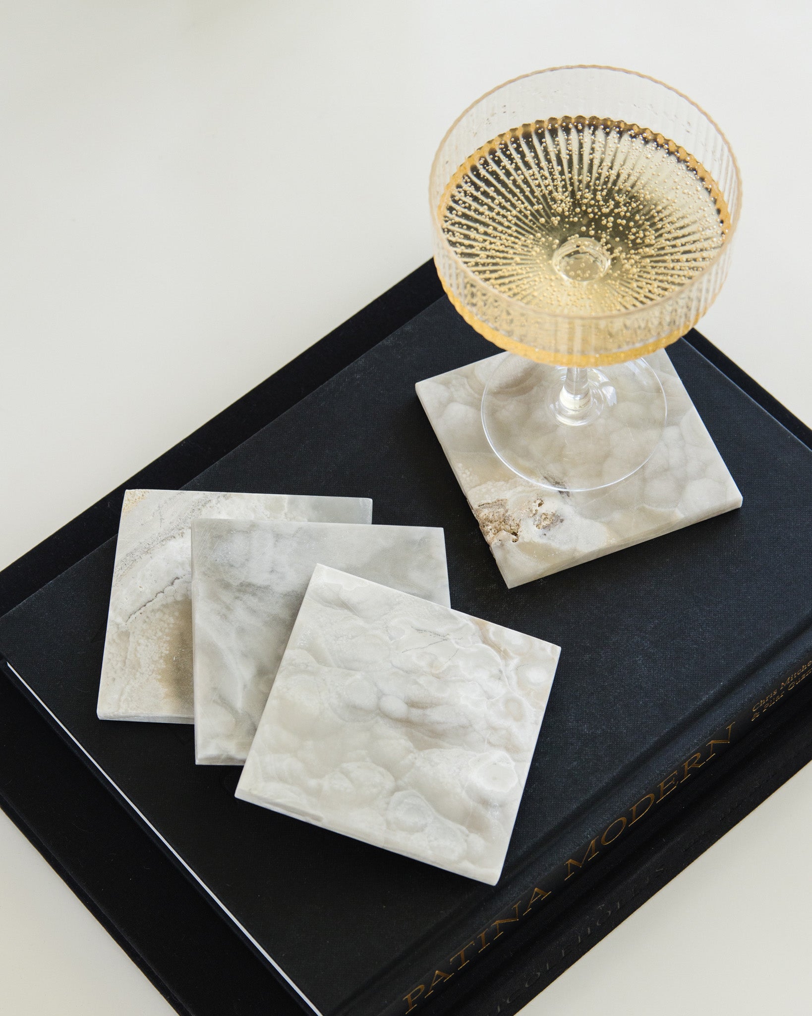 Set of four grey onyx drink coasters featuring natural stone patterns and polished finish