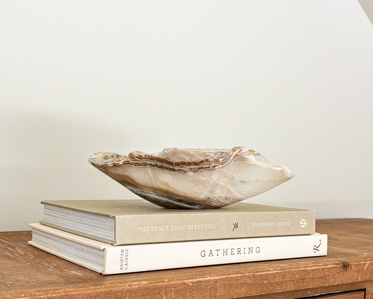 Hand-carved amber onyx bowl with warm golden tones and natural stone veining