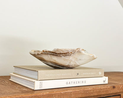Hand-carved amber onyx bowl with warm golden tones and natural stone veining
