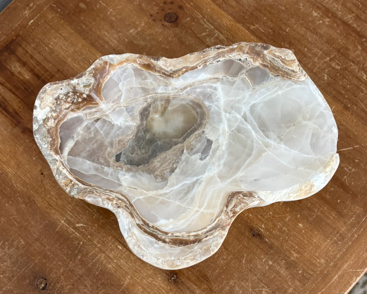 Natural amber onyx bowl with distinctive mineral banding and polished finish