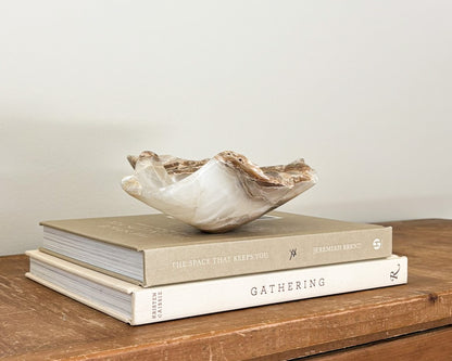 Artisan-carved amber onyx bowl with warm caramel and cream-colored veining