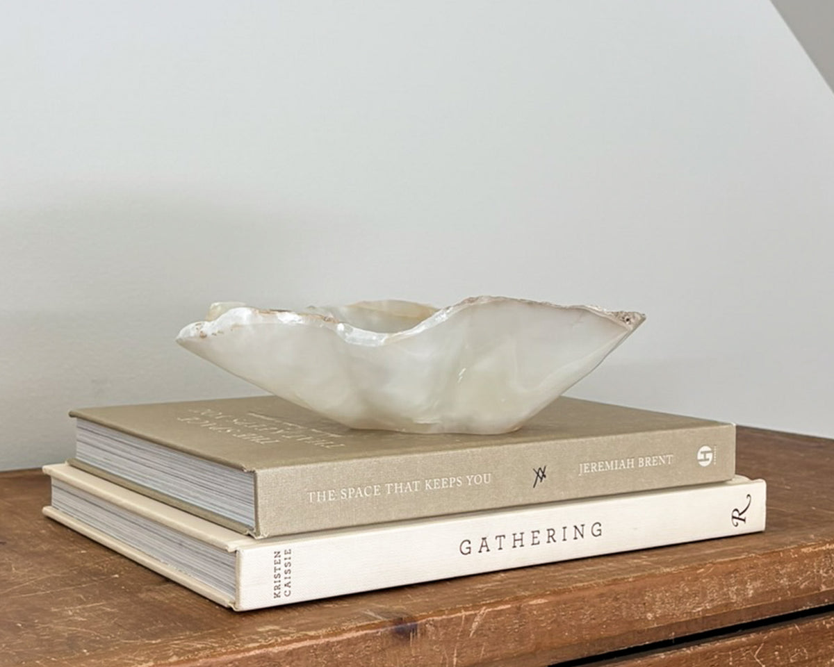 Polished amber onyx stone bowl with unique natural patterns and translucent details