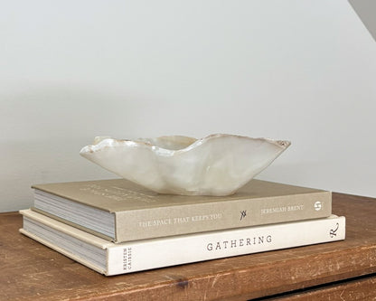 Polished amber onyx stone bowl with unique natural patterns and translucent details