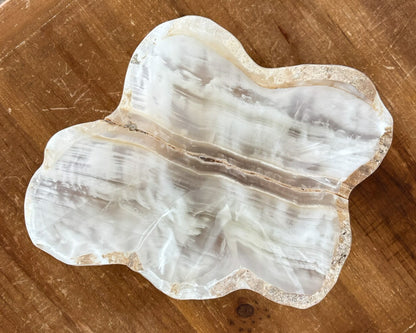 Hand-carved onyx decorative bowl in warm amber, honey, and ivory tones