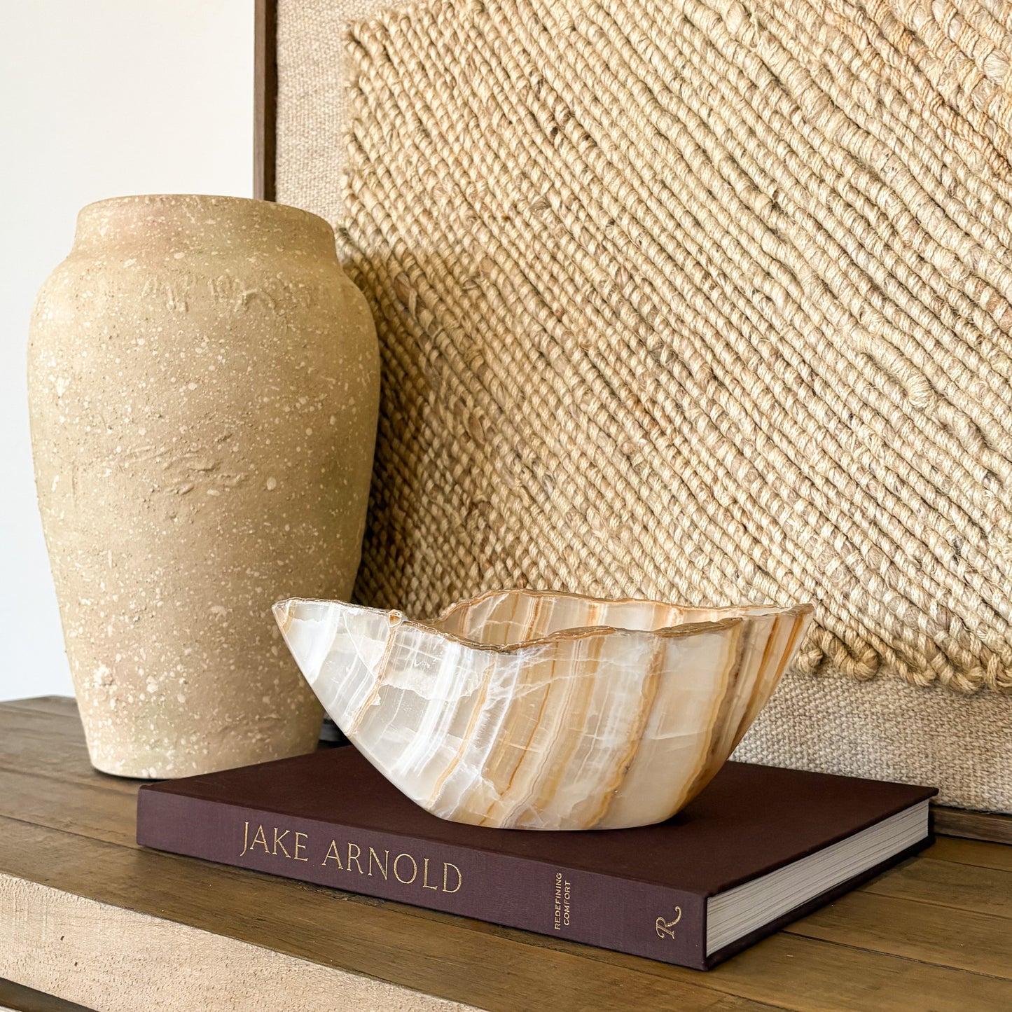 Artisan hand carved amber onyx bowl with glowing golden stone layers, elegant natural mineral home accent.
