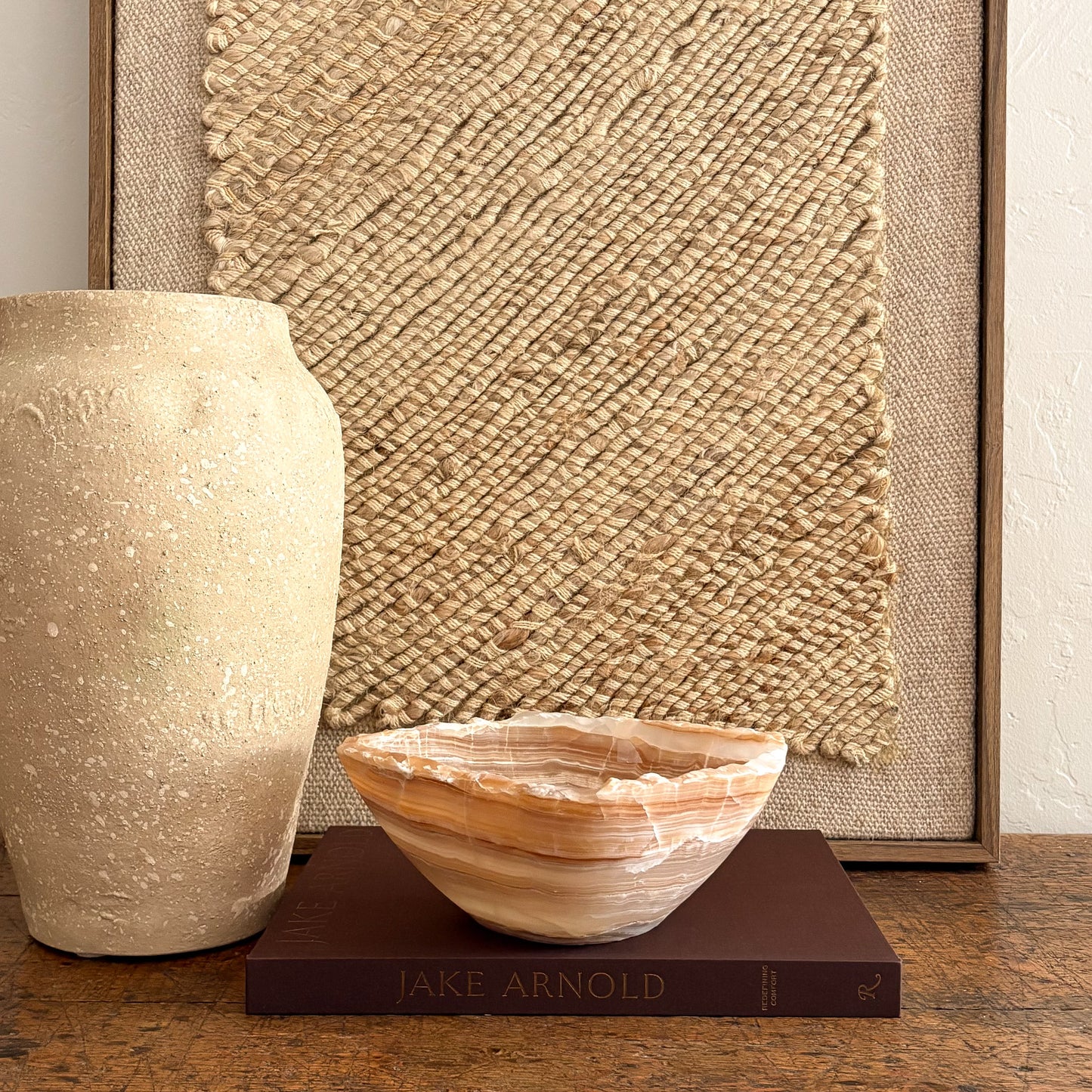 Handcrafted amber onyx stone bowl, glowing light through layered veins