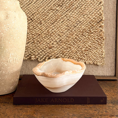 Small hand-carved amber onyx catchall bowl, luminous banded stone
