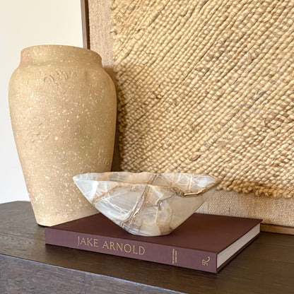 Hand carved amber onyx bowl displayed on modern dining table decor
