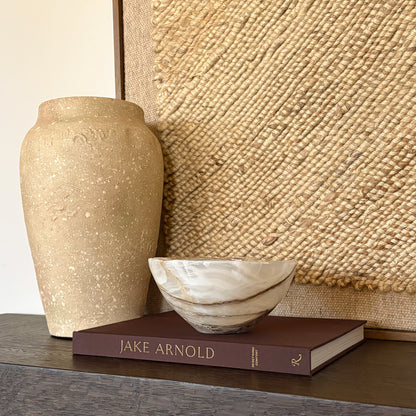 Handmade amber onyx stone bowl with smooth carved edges and rich color