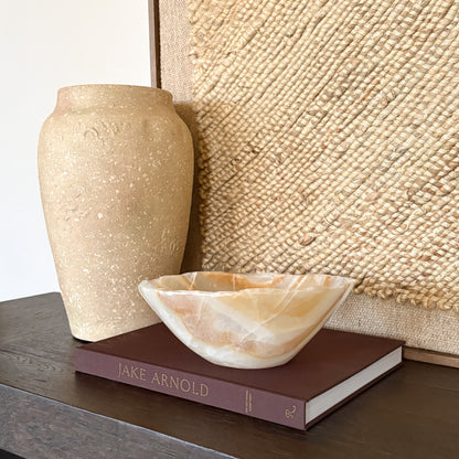 Hand carved amber onyx bowl with natural stone veining and polished finish