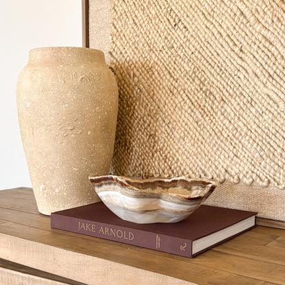 Artisan hand carved amber onyx bowl showcasing polished natural stone luxury decor