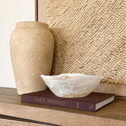 Artisan hand carved amber onyx bowl featuring unique natural stone patterns