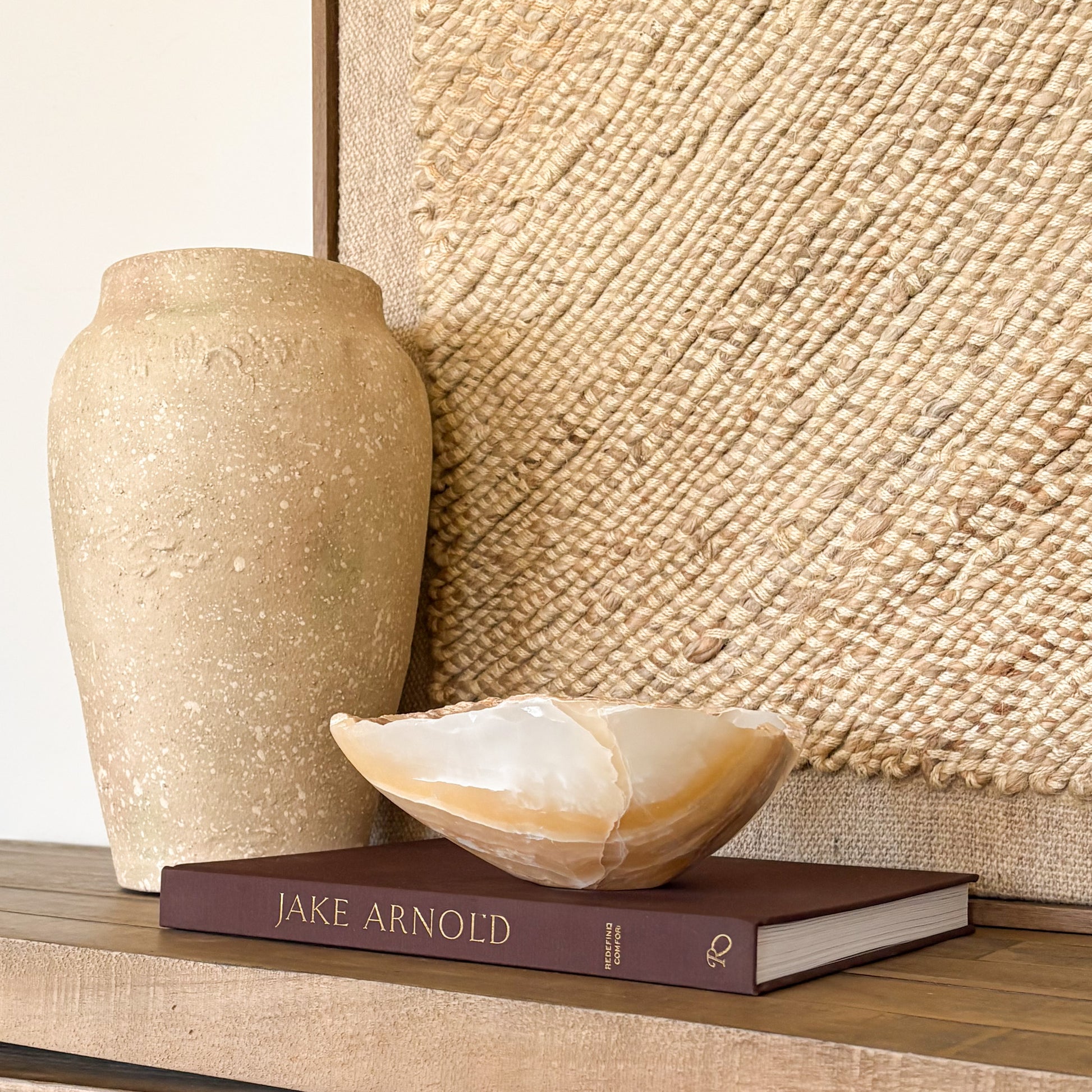 Hand carved amber onyx bowl used as a luxury accent piece in refined home interiors