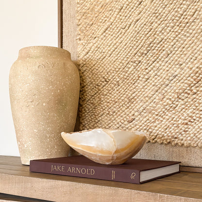 Hand carved amber onyx bowl used as a luxury accent piece in refined home interiors