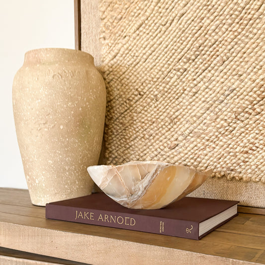 Artisan hand carved amber onyx bowl showcasing polished natural stone luxury decor