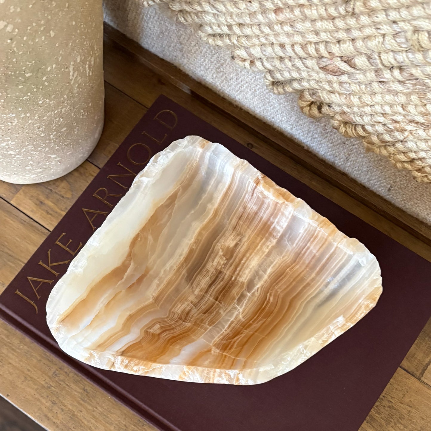 Hand carved amber onyx bowl used as a decorative centerpiece on table