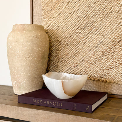 Sculpted amber onyx bowl with organic stone texture