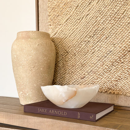 Polished amber onyx decorative bowl in warm golden tones