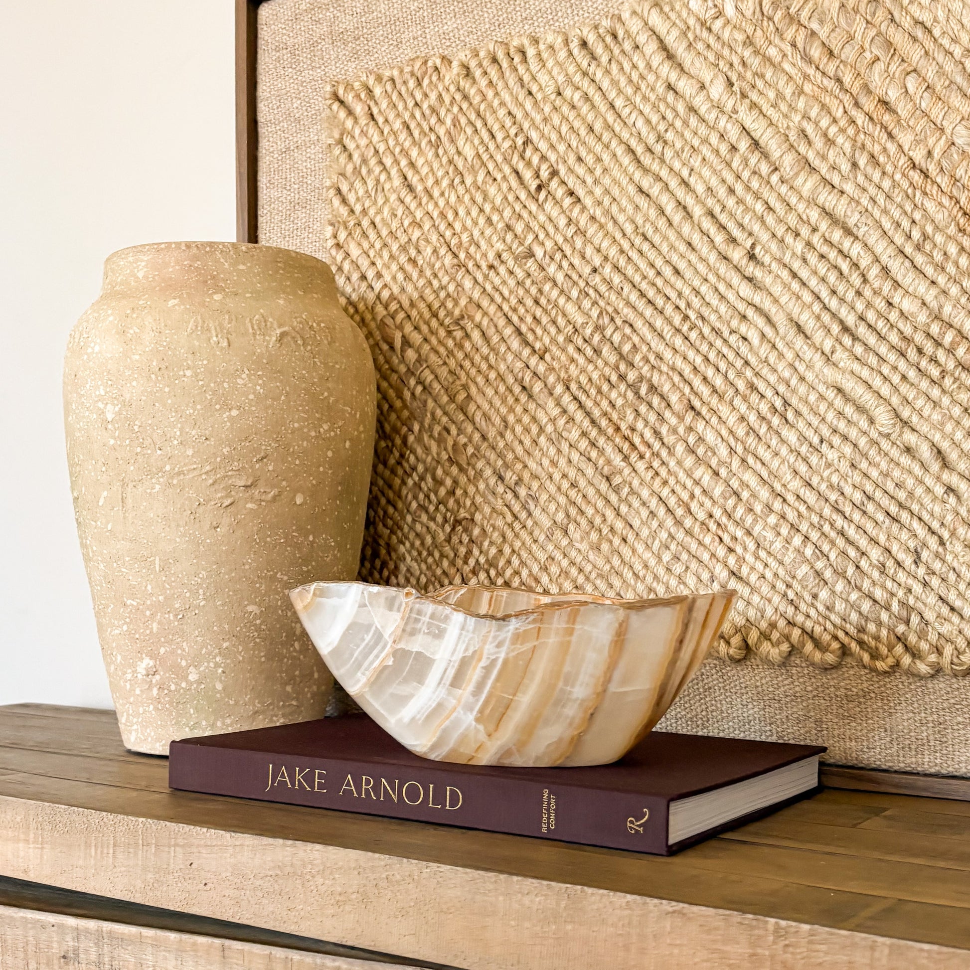 Elegant hand carved amber onyx bowl featuring warm golden stone veining, luxury decorative stone centerpiece.